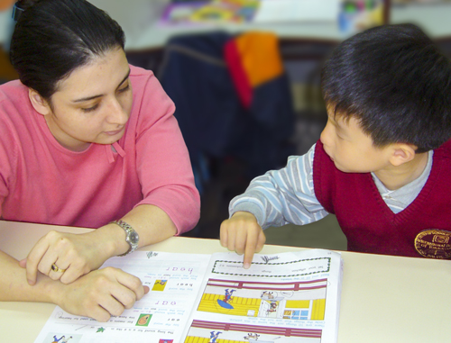 Educational Assistant helping a child. 